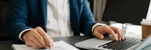 business documents on office table with smart phone and digital tablet and graph financial and woman working at modern office