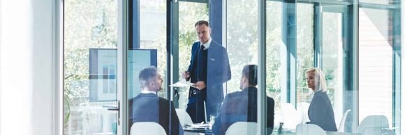 Full length shot of a group of corporate businesspeople meeting in the boardroom.